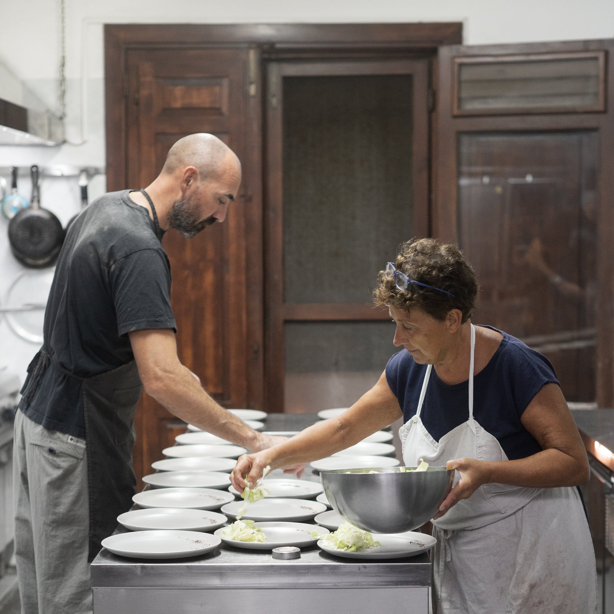 Principe chefs preparing food in a kitchen.